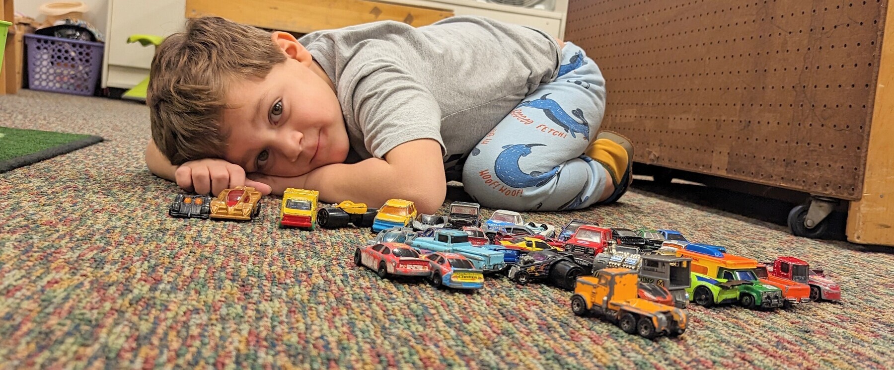 preschool student playing with cars